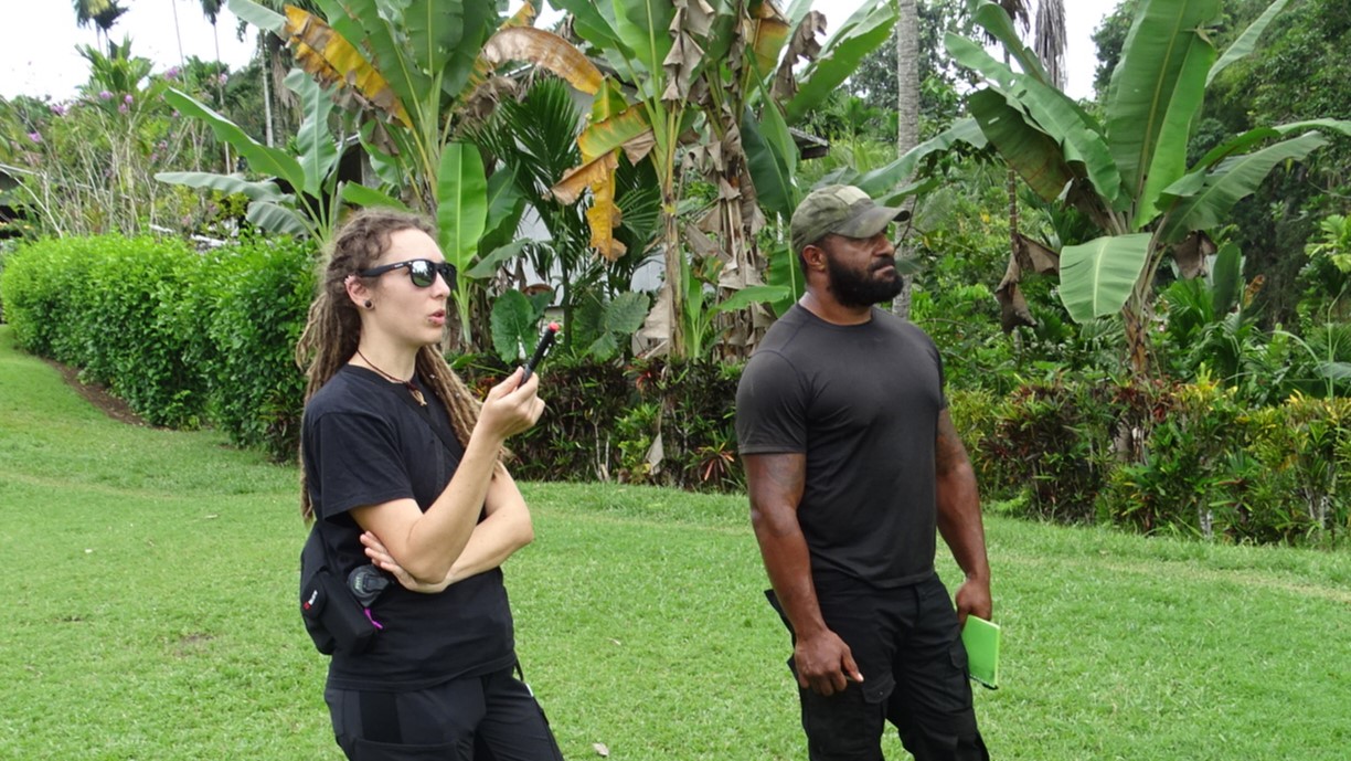 Young solar engineers (woman and man) judging the suitability of a solar power station in a village in Papua New Guinea